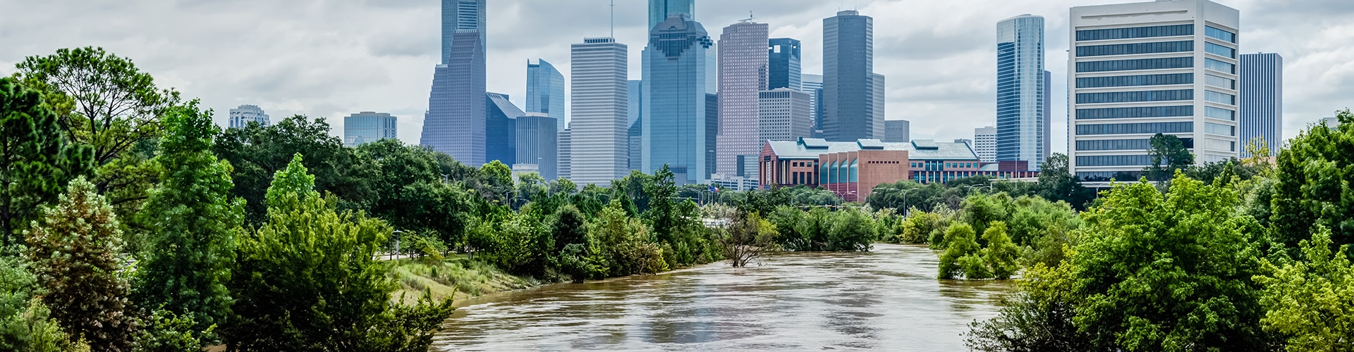 High And Fast Water Rising In Bayou River With Downtown Houston